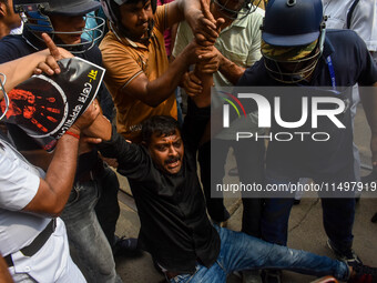 Police arrest supporters of the Indian National Congress during a protest against the rape and murder of a junior doctor in Kolkata, India,...