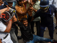 Police arrest supporters of the Indian National Congress during a protest against the rape and murder of a junior doctor in Kolkata, India,...