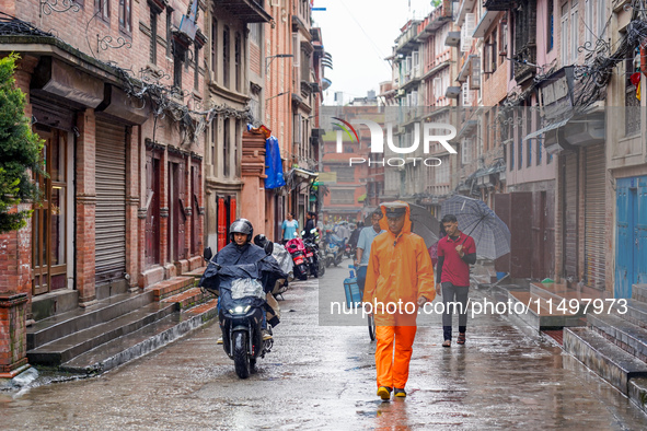 People's daily lives are affected by the heavy rainfall in Kathmandu, Nepal, on August 21, 2024. 