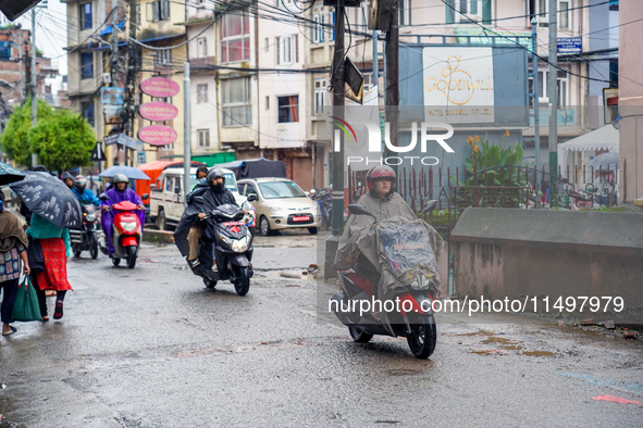 People's daily lives are affected by the heavy rainfall in Kathmandu, Nepal, on August 21, 2024. 