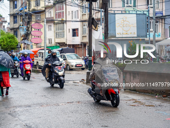 People's daily lives are affected by the heavy rainfall in Kathmandu, Nepal, on August 21, 2024. (