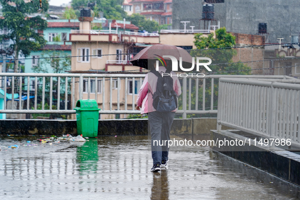 People's daily lives are affected by the heavy rainfall in Kathmandu, Nepal, on August 21, 2024. 