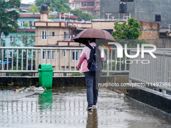 People's daily lives are affected by the heavy rainfall in Kathmandu, Nepal, on August 21, 2024. (