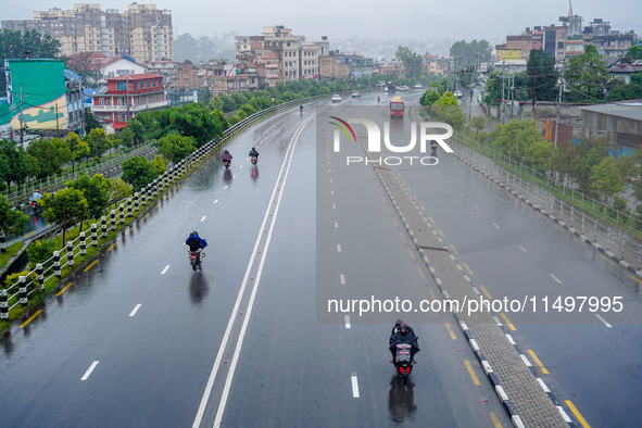 People's daily lives are affected by the heavy rainfall in Kathmandu, Nepal, on August 21, 2024. 