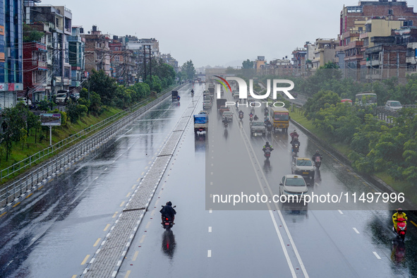 People's daily lives are affected by the heavy rainfall in Kathmandu, Nepal, on August 21, 2024. 