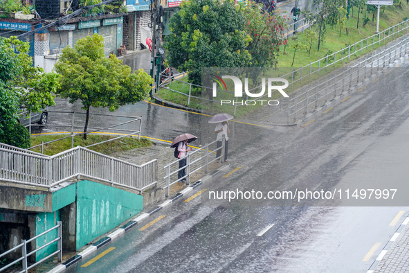 People's daily lives are affected by the heavy rainfall in Kathmandu, Nepal, on August 21, 2024. 