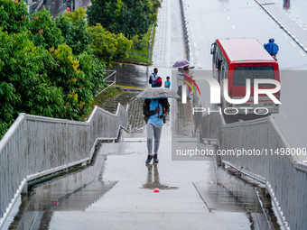 People's daily lives are affected by the heavy rainfall in Kathmandu, Nepal, on August 21, 2024. (