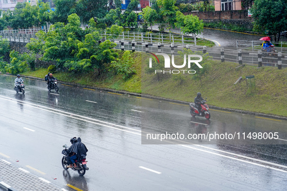 People's daily lives are affected by the heavy rainfall in Kathmandu, Nepal, on August 21, 2024. 