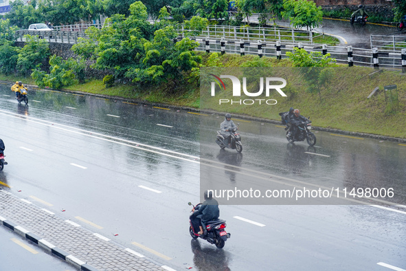 People's daily lives are affected by the heavy rainfall in Kathmandu, Nepal, on August 21, 2024. 