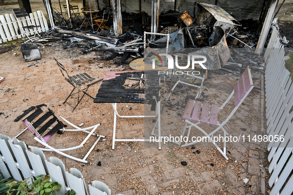 Burnt-out tables and chairs are at the Levada children's cafe in the central park destroyed by a Russian artillery shell strike in Malokater...