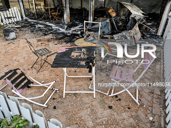 Burnt-out tables and chairs are at the Levada children's cafe in the central park destroyed by a Russian artillery shell strike in Malokater...