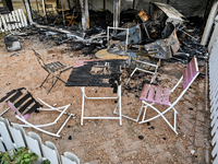 Burnt-out tables and chairs are at the Levada children's cafe in the central park destroyed by a Russian artillery shell strike in Malokater...