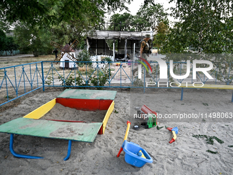 Toys are scattered at a playground near the Levada children's cafe in the central park damaged by a Russian artillery shell strike in Maloka...