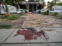 A blood stain of one of the children wounded by a Russian artillery shell strike on the Levada cafe is on the ground in the central park in...