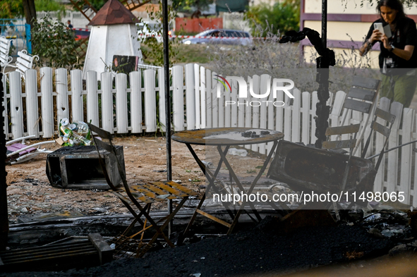 A burnt-out table and chairs are at the Levada children's cafe in the central park destroyed by a Russian artillery shell strike in Malokate...