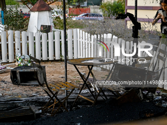 A burnt-out table and chairs are at the Levada children's cafe in the central park destroyed by a Russian artillery shell strike in Malokate...