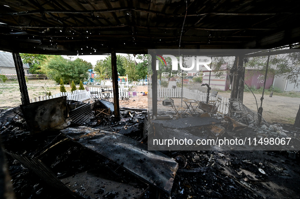 Burnt-out tables and chairs are at the Levada children's cafe in the central park destroyed by a Russian artillery shell strike in Malokater...