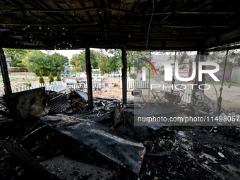 Burnt-out tables and chairs are at the Levada children's cafe in the central park destroyed by a Russian artillery shell strike in Malokater...