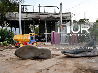 A pair of sneakers of one of the children wounded by a Russian artillery shell strike on the Levada cafe is on the ground in the central par...