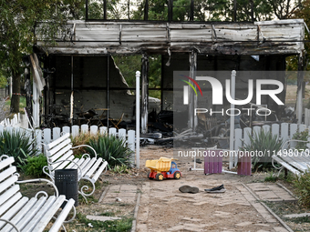 A toy truck is seen outside the Levada children's cafe in the central park damaged by a Russian artillery shell strike in Malokaterynivka vi...