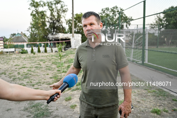 Volodymyr Sosunovskyi, head of the Kushuhum community, speaks to the press near the Levada cafe in the central park destroyed by a Russian a...