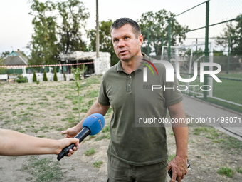 Volodymyr Sosunovskyi, head of the Kushuhum community, speaks to the press near the Levada cafe in the central park destroyed by a Russian a...