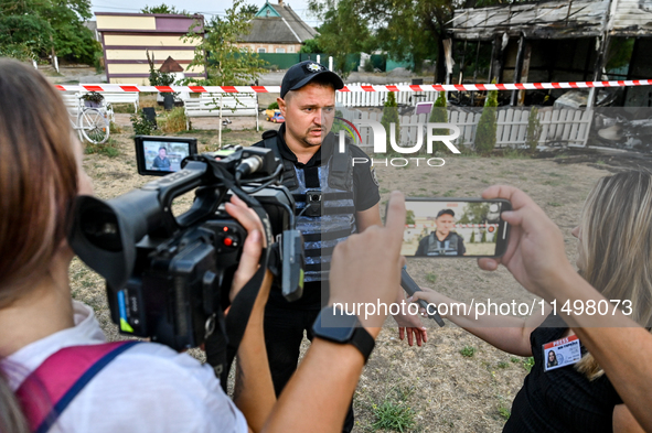 Serhii Volyk, a police officer of the Kushuhum community who administers first aid to wounded children, speaks to the press near the Levada...