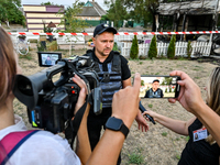 Serhii Volyk, a police officer of the Kushuhum community who administers first aid to wounded children, speaks to the press near the Levada...