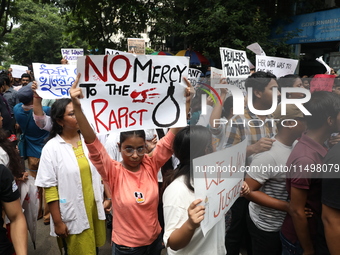 Medical students and doctors attend a protest rally against the rape and murder of a PGT woman doctor at Government-run R G Kar Medical Coll...