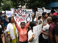 Medical students and doctors attend a protest rally against the rape and murder of a PGT woman doctor at Government-run R G Kar Medical Coll...