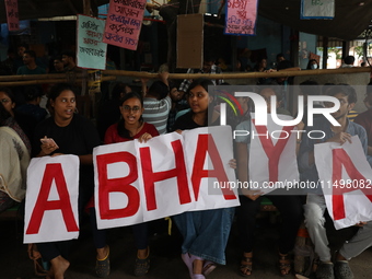 Medical students hold placards protesting against the rape and murder of a PGT woman doctor at Government-run R G Kar Medical College & Hosp...