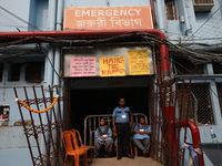 Security officials guard outside the medical emergency ward under a few posters at Government-run R G Kar Medical College & Hospital in Kolk...