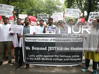 Medical students and doctors attend a protest rally against the rape and murder of a PGT woman doctor at Government-run R G Kar Medical Coll...