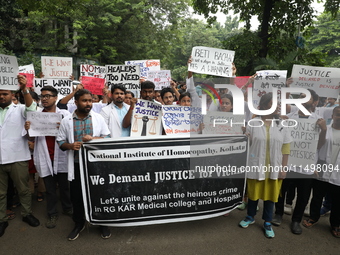 Medical students and doctors attend a protest rally against the rape and murder of a PGT woman doctor at Government-run R G Kar Medical Coll...