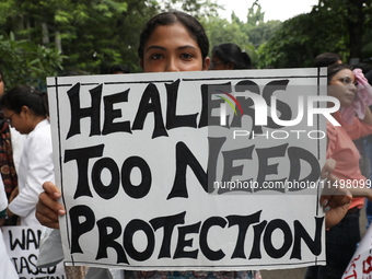 Medical students and doctors attend a protest rally against the rape and murder of a PGT woman doctor at Government-run R G Kar Medical Coll...