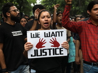 Medical students and doctors attend a protest rally against the rape and murder of a PGT woman doctor at Government-run R G Kar Medical Coll...