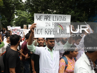 Medical students and doctors attend a protest rally against the rape and murder of a PGT woman doctor at Government-run R G Kar Medical Coll...