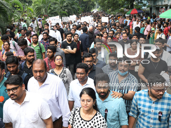 Medical students and doctors attend a protest rally against the rape and murder of a PGT woman doctor at Government-run R G Kar Medical Coll...