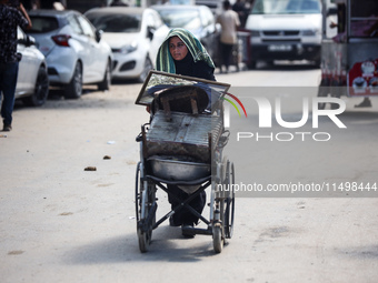 Palestinians flee with their belongings in Deir el-Balah, Gaza Strip, on August 21, 2024, amid the ongoing conflict between Israel and the H...