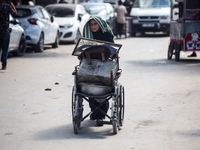 Palestinians flee with their belongings in Deir el-Balah, Gaza Strip, on August 21, 2024, amid the ongoing conflict between Israel and the H...