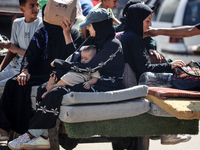 Palestinians flee with their belongings in Deir el-Balah, Gaza Strip, on August 21, 2024, amid the ongoing conflict between Israel and the H...