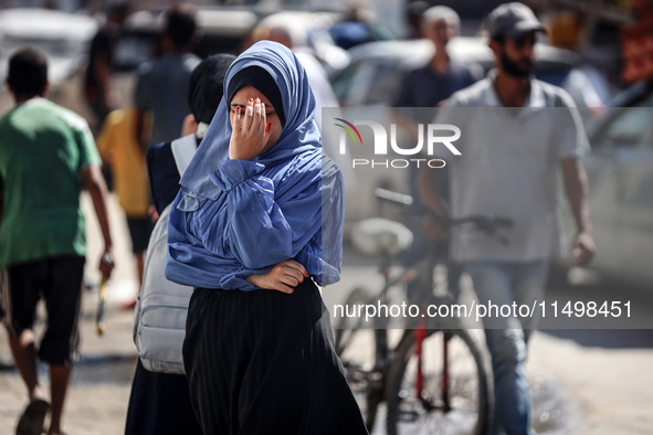 Palestinians flee with their belongings in Deir el-Balah, Gaza Strip, on August 21, 2024, amid the ongoing conflict between Israel and the H...