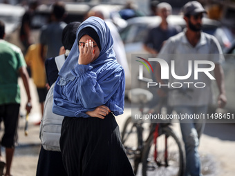 Palestinians flee with their belongings in Deir el-Balah, Gaza Strip, on August 21, 2024, amid the ongoing conflict between Israel and the H...