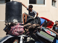 Palestinians flee with their belongings in Deir el-Balah, Gaza Strip, on August 21, 2024, amid the ongoing conflict between Israel and the H...