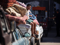 Palestinians flee with their belongings in Deir el-Balah, Gaza Strip, on August 21, 2024, amid the ongoing conflict between Israel and the H...