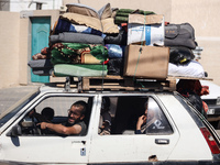 Palestinians flee with their belongings in Deir el-Balah, Gaza Strip, on August 21, 2024, amid the ongoing conflict between Israel and the H...