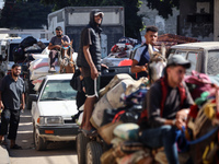 Palestinians flee with their belongings in Deir el-Balah, Gaza Strip, on August 21, 2024, amid the ongoing conflict between Israel and the H...