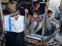 Palestinians flee with their belongings in Deir el-Balah, Gaza Strip, on August 21, 2024, amid the ongoing conflict between Israel and the H...