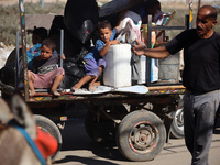 Palestinians flee with their belongings in Deir el-Balah, Gaza Strip, on August 21, 2024, amid the ongoing conflict between Israel and the H...