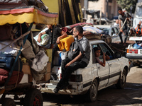 Palestinians flee with their belongings in Deir el-Balah, Gaza Strip, on August 21, 2024, amid the ongoing conflict between Israel and the H...